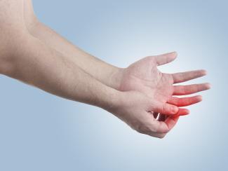 man holding painful finger
