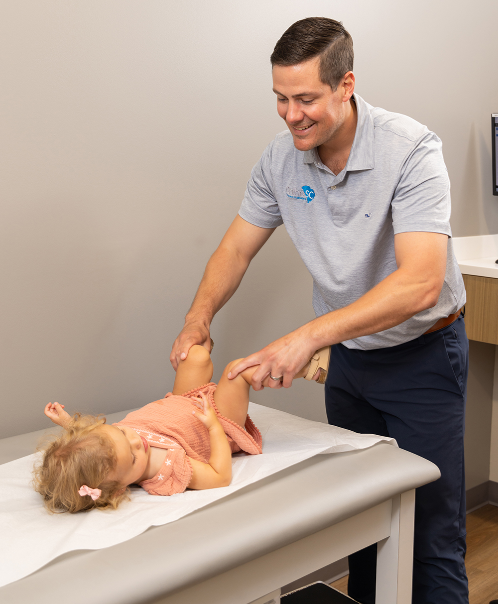 doctor examining infant's legs