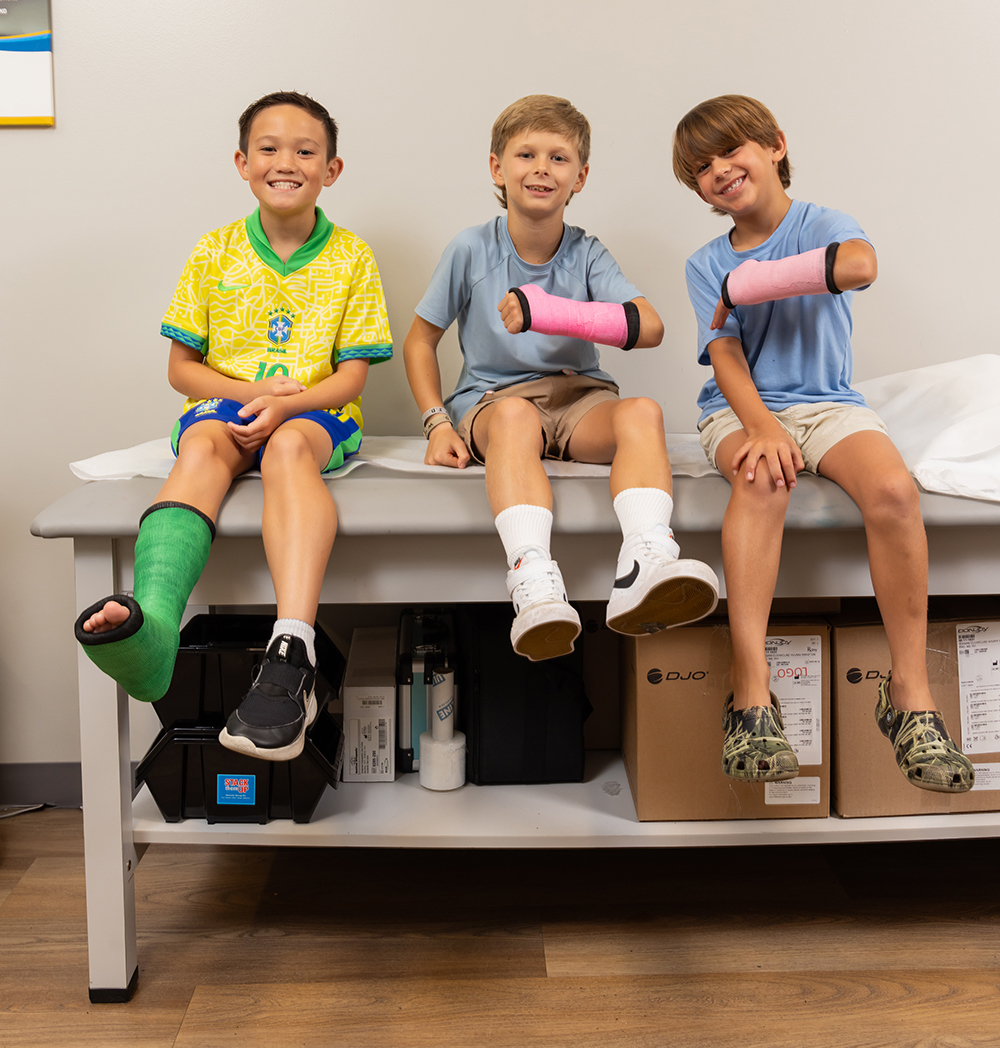 boys with casts on arms and leg