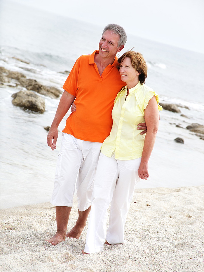 mature couple walking on beach