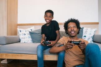 Father and son playing video games