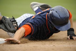 Baseball player sliding into a base