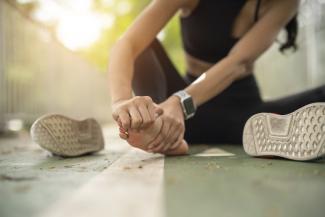 Woman holding painful foot