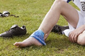 Soccer player icing their ankle