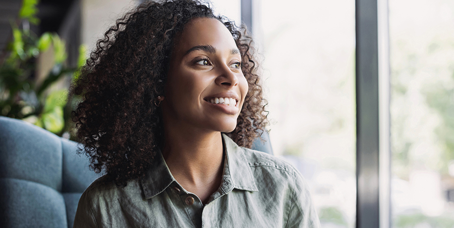 smiling woman looking out window